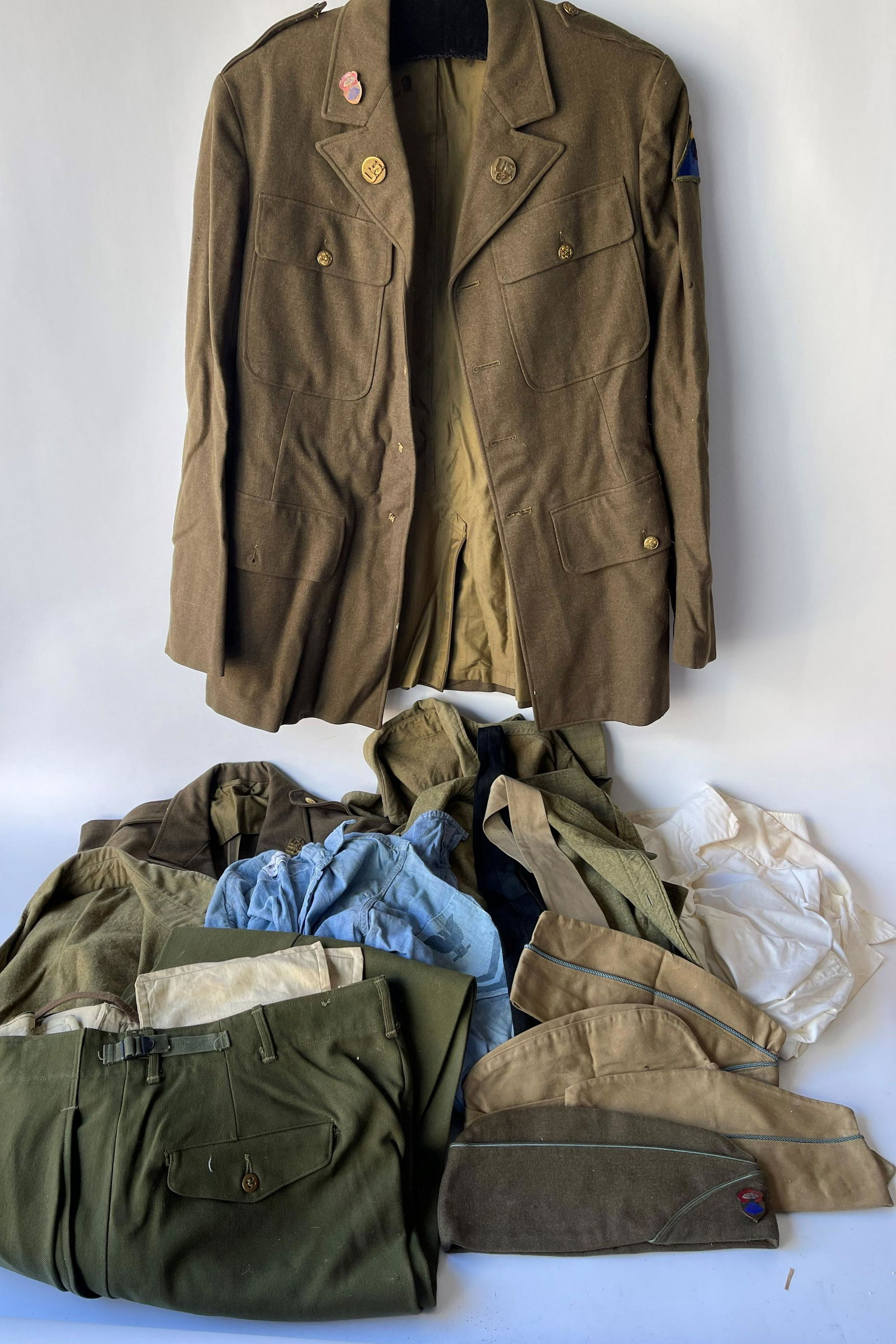 GROUPING OF MILITARY CLOTHES SHIRTS, JACKETS, PANTS, CAPS (1 of 6)