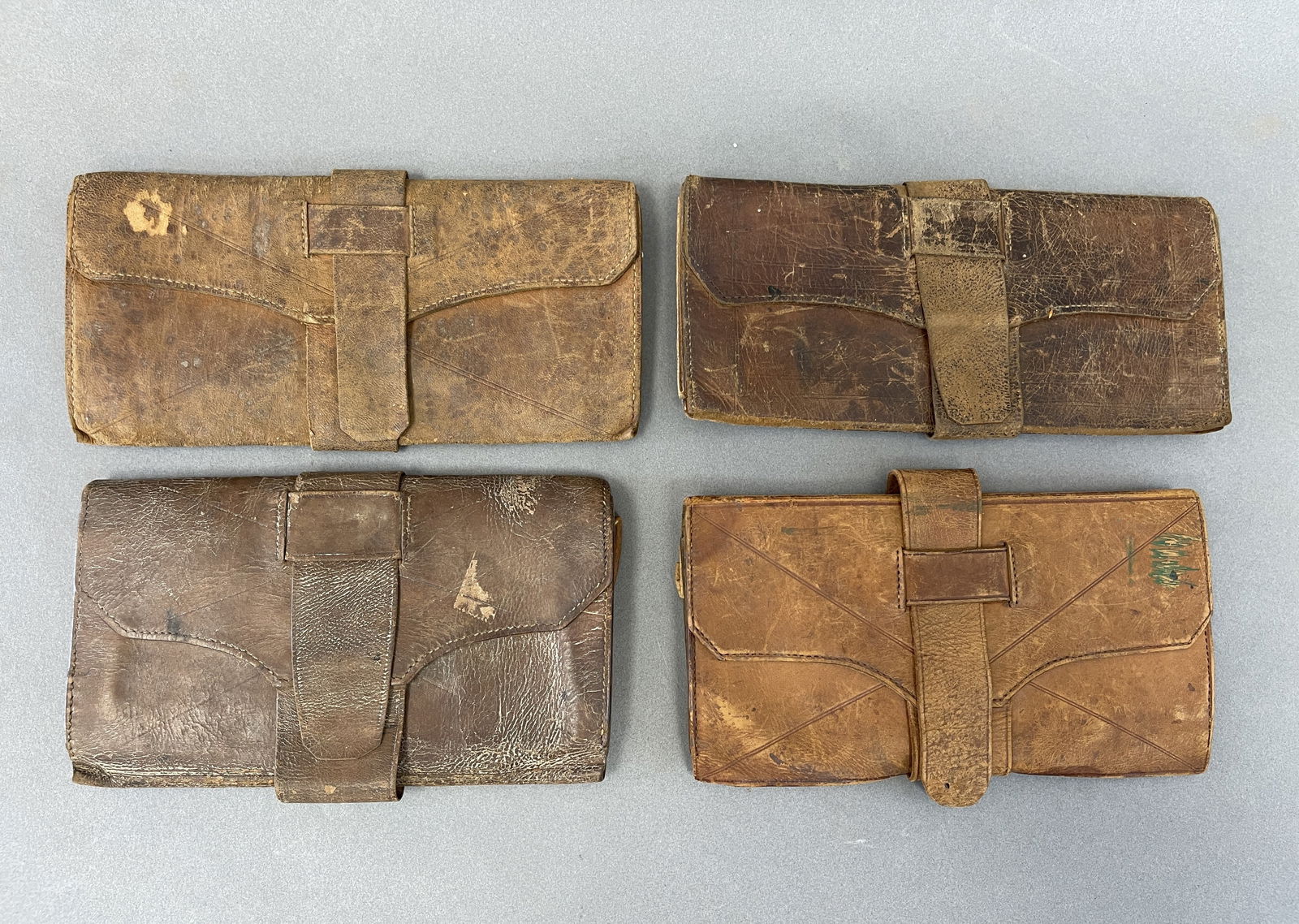 GROUPING OF FOUR PRIMITIVE LEATHER WALLETS 3 X 5 (1 of 2)