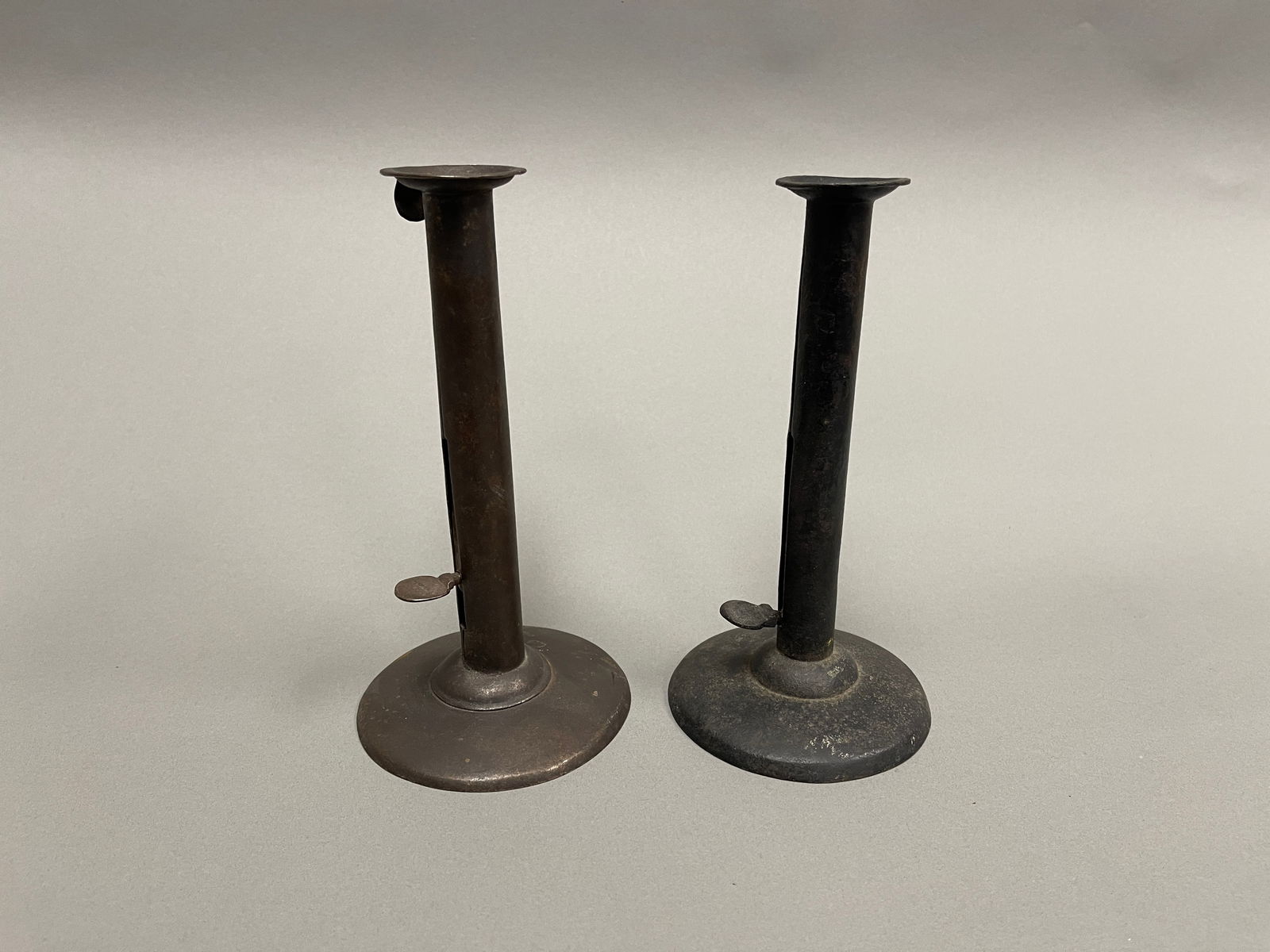 TWO EARLY IRON HOGSCRAPER PUSHUP CANDLESTICKS (1 of 3)