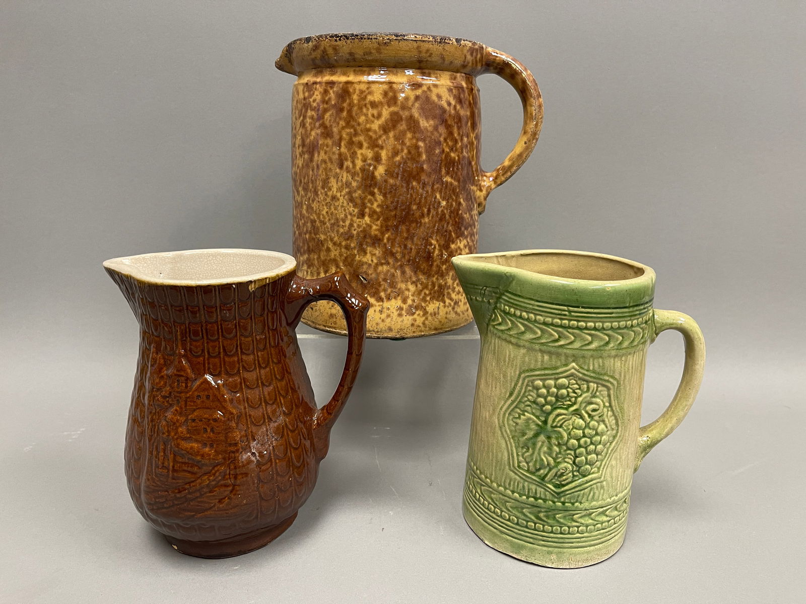 THREE PRIMITIVE STONEWARE PITCHERS (1 of 2)