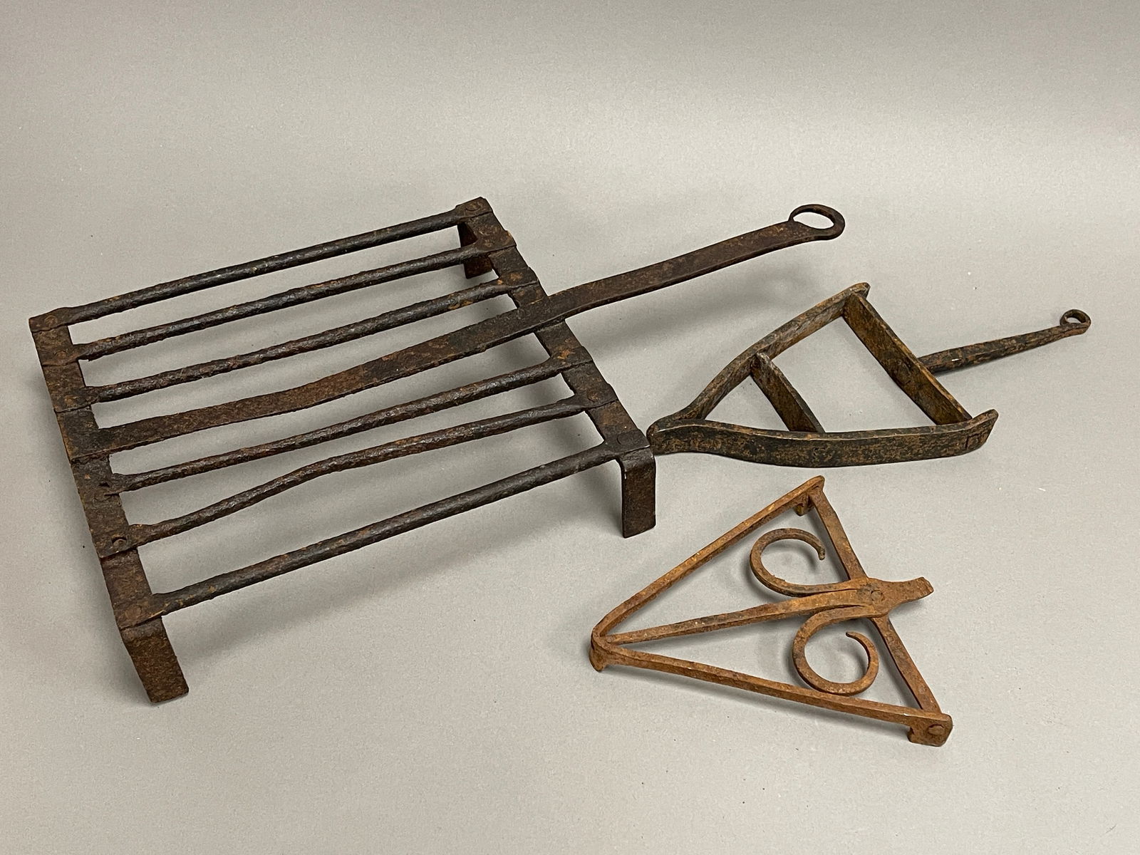 GROUPING OF 18TH C IRON TRIVETS: GROUPING OF 18TH C IRON TRIVETS, 9 X 16.5 X 2.5 / 5 X 11 / 6.5 X 6