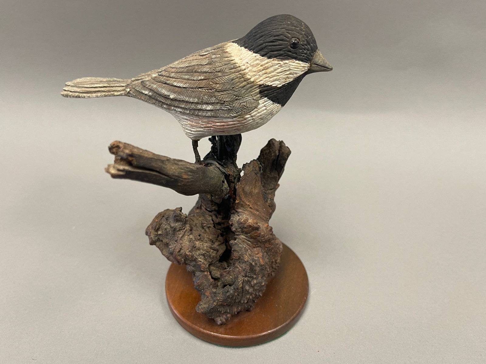 CARVED AND PAINTED BIRD ON A BRANCH: C 1940 CARVED /PAINTED WOODEN CHICKADEE MOUNTED ON NATURAL TREE BRANCH 6"W X 7"H.