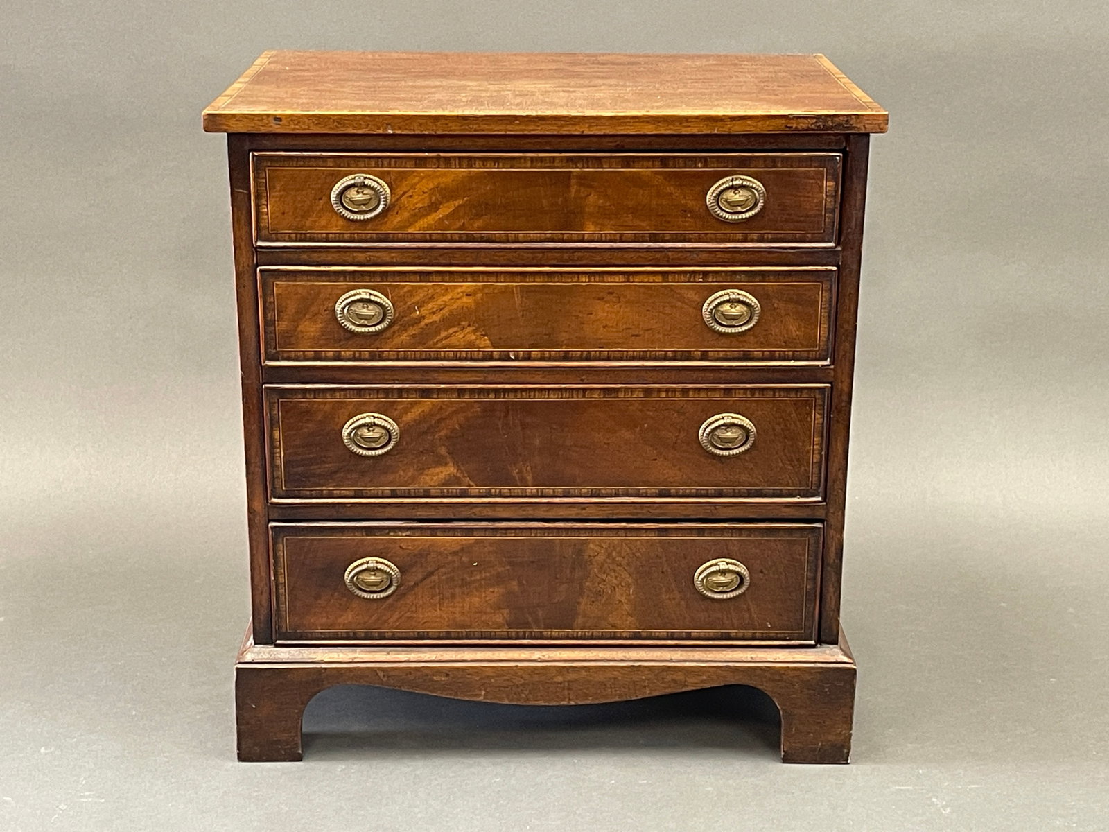19TH C GEORGIAN MAHOGANY FOUR DRAWER MINI CHEST ENHANCED WITH INLAY: 19TH C GEORGIAN MAHOGANY FOUR DRAWER MINI CHEST ENHANCED WITH INLAY 20.25" X 19" X 13"