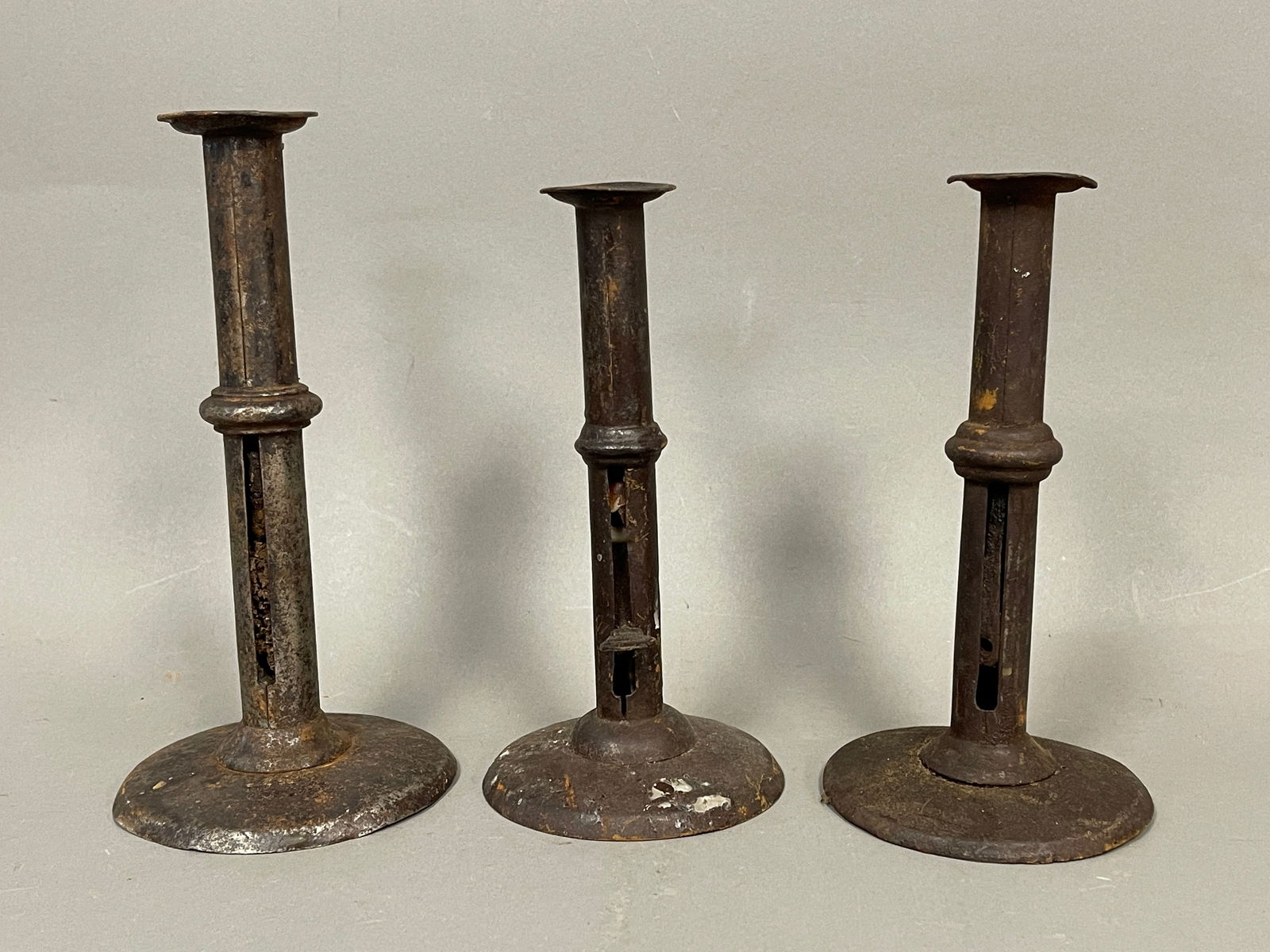 THREE IRON PUSH UP CANDLESTICKS WITH WEDDING RING BANDS (1 of 3)