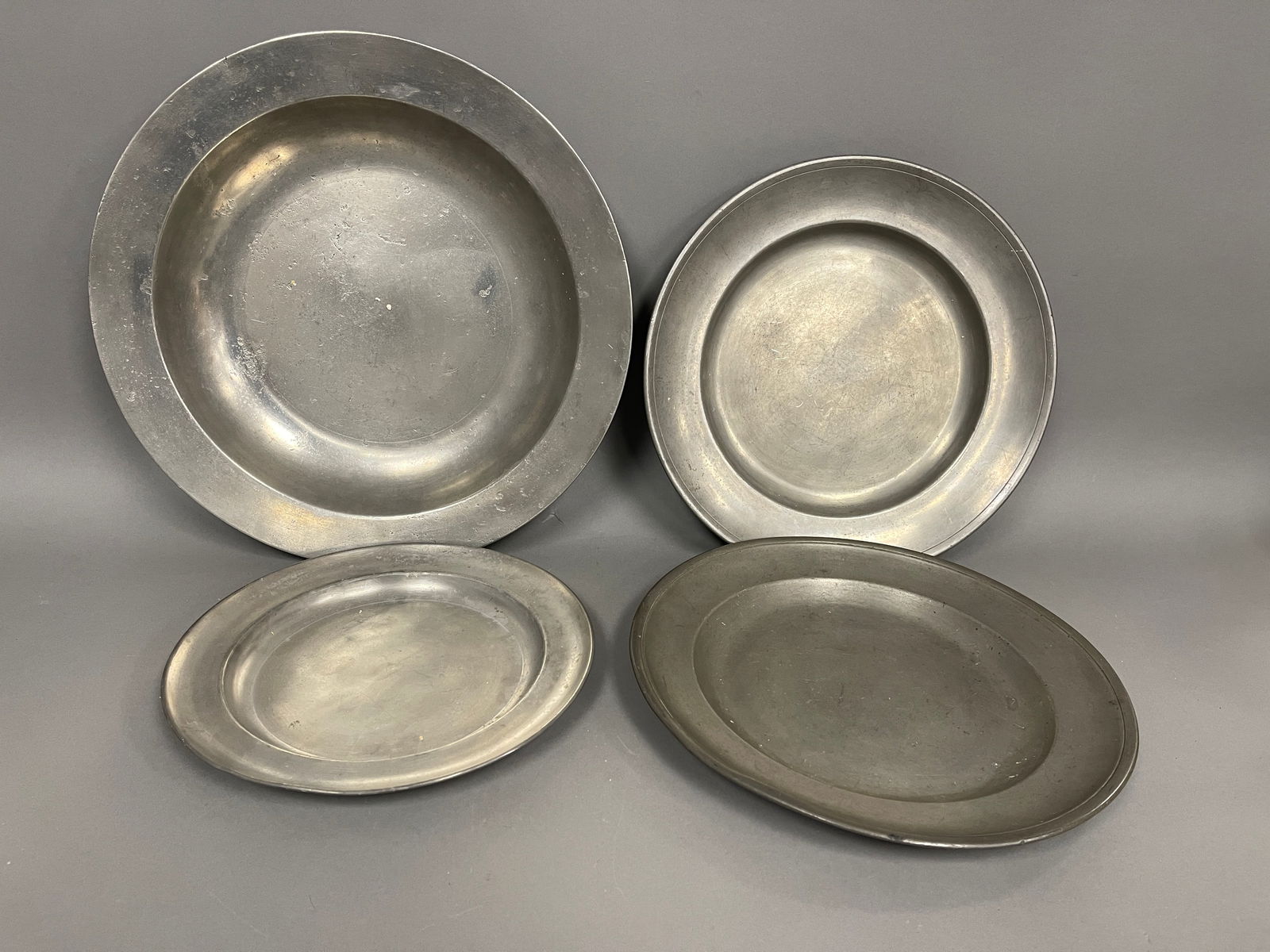 FOUR EARLY PEWTER CHARGERS (1 of 4)