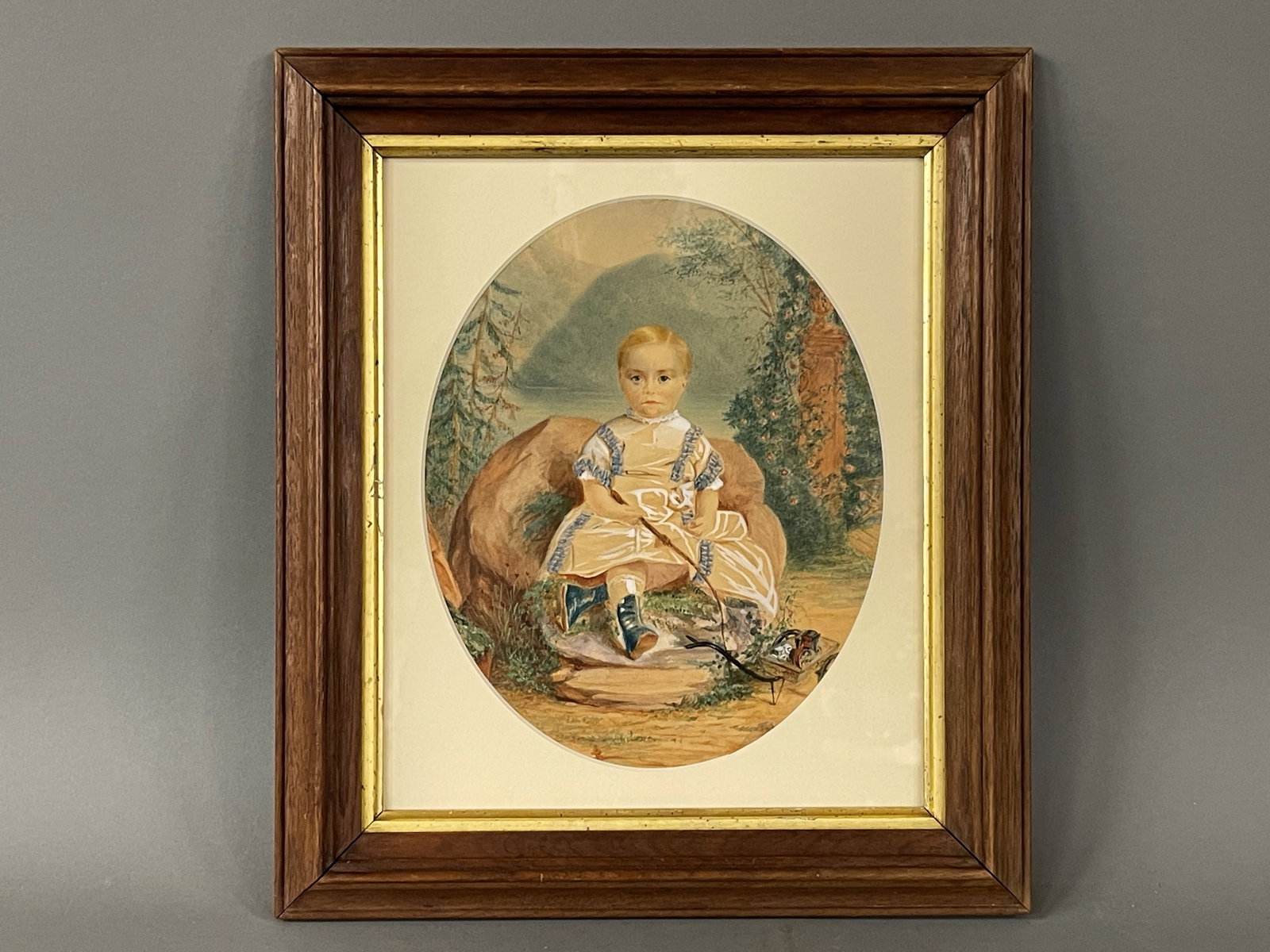 19TH C WATERCOLOR PORTRAIT OF A BOY: 19TH C WATERCOLOR PORTRAIT OF A BOY C 1830-40 WATERCOLOR OF A LITTLE BOY WITH HIS WHIP AND TOYS WITH THE BACKGROUND. FROM A NEW YORK COLLECTION IT IS ATTRIBUTED TO THE HUDSON RIVER SCHOOL ~ WATERCOLOR