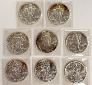 EIGHT SILVER EAGLE COINS 1985, 1986, 1987