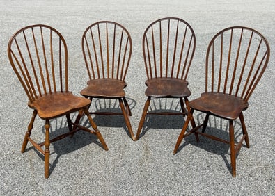 A SET OF 4 SEVEN SPINDLE BOW BACK WINDSOR CHAIRS