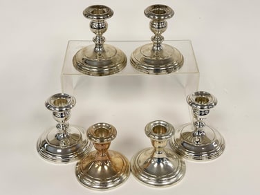 THREE PAIRS OF STERLING WEIGHTED CANDLESTICKS