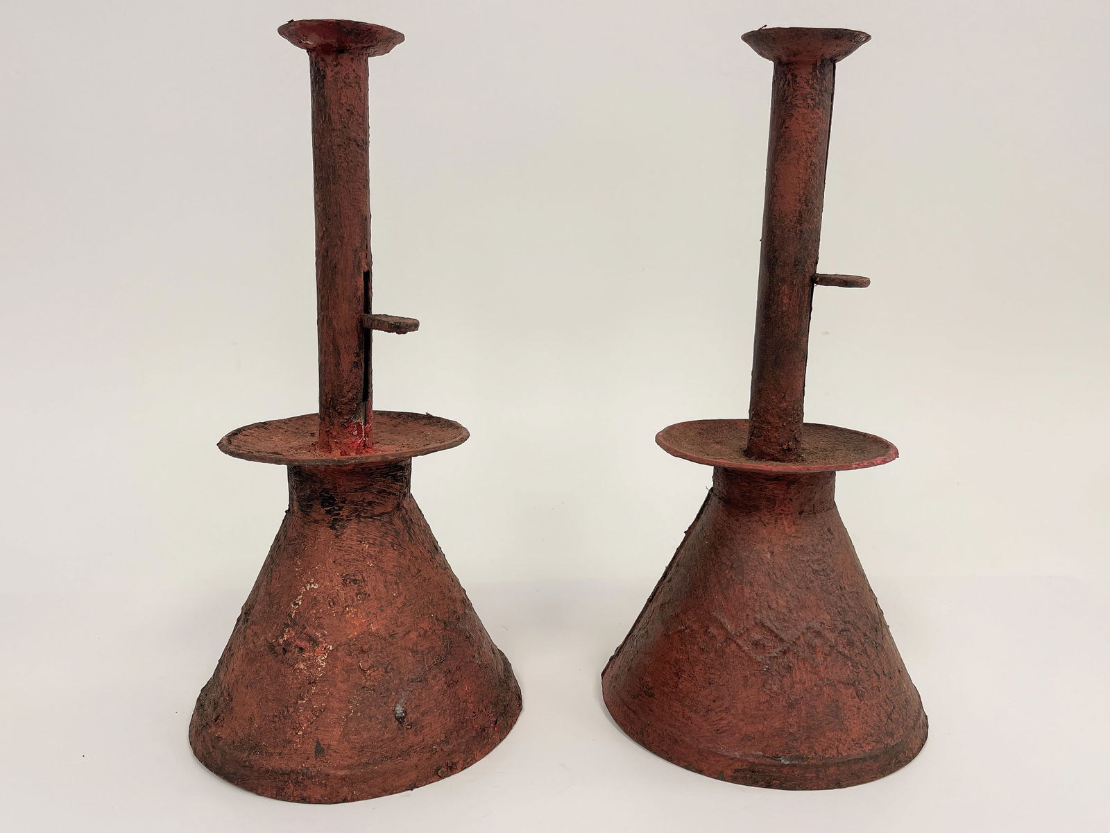 PAIR OF SHEET IRON SAND BASED PUSH UP CANDLESTICKS IN THE OLD CRAZILY RED PAINT FINISH (1 of 3)