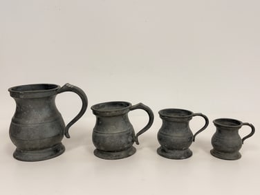 FIVE PEWTER HANDLED MEASURING TANKARDS