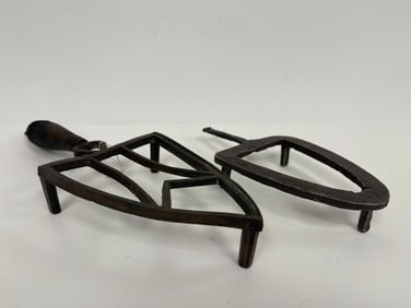 TWO EARLY IRON TRIVETS, ONE W/ HEART