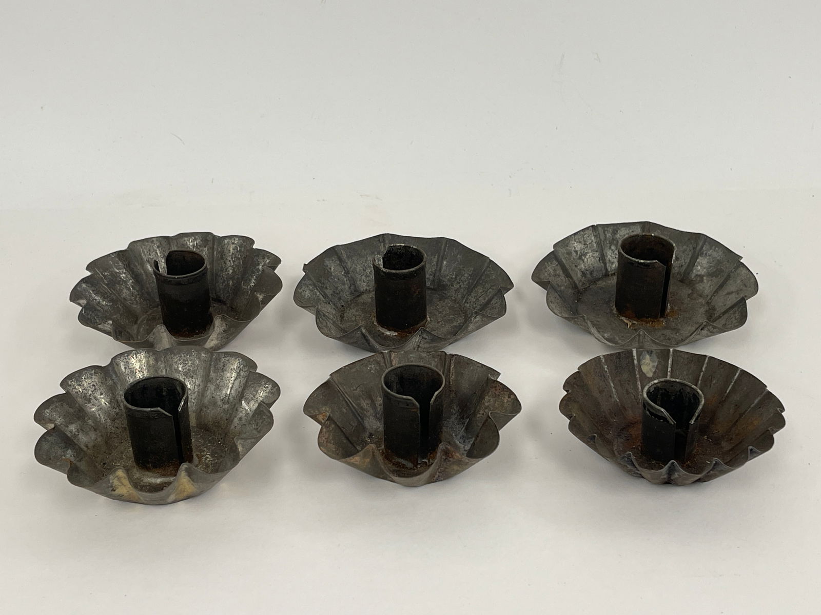 SIX TIN CANDLE CUPS WITH CRIMPED EDGES: SIX TIN CANDLE CUPS WITH CRIMPED EDGES