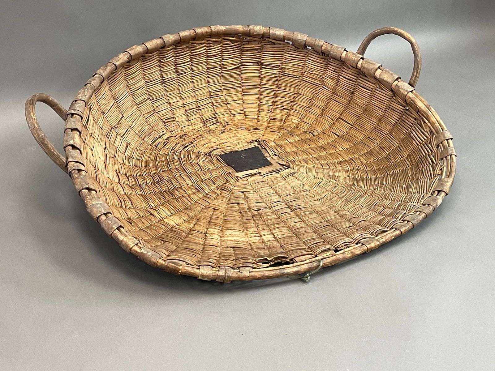 19TH C WINNOWING BASKET W/2 NOTCHED BENTWOOD HANDLES: 19TH C WINNOWING BASKET W/2 NOTCHED BENTWOOD HANDLES 32" X 38"