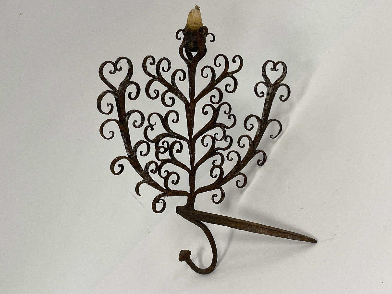 FORGED IRON FOLIATED STICKING TOMMY: HUGE AND WONDERFUL FORGED IRON FOLIATED STICKING TOMMY WITH THREE ARMS AND CENTRAL CANDLE HOLDER11" x 12"