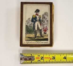 EARLY 19THC CARDBOARD BOX SHOWING NAPOLEON W/ AN EXPLODING BOMB, SYMBOLIZING WAR