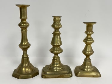 THREE BRASS PUSH UP CANDLESTICKS