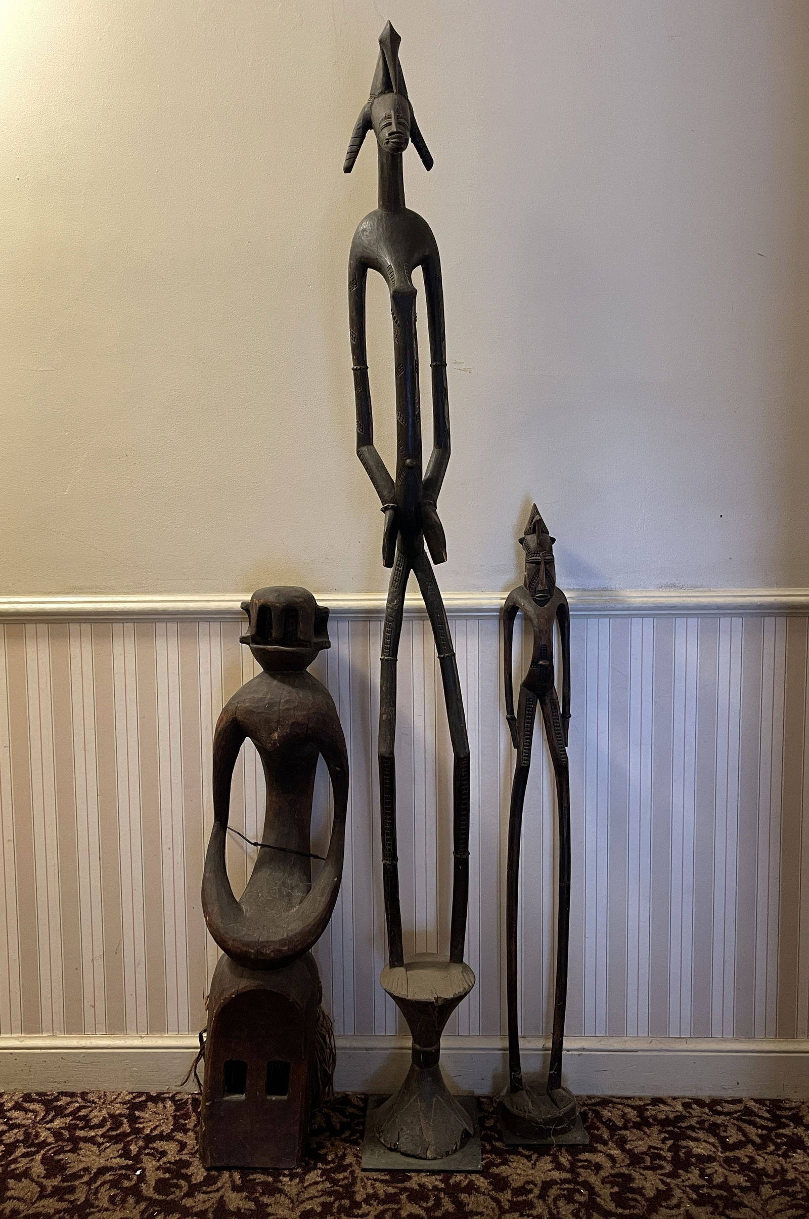 THREE TALL CARVED TRIBAL FIGURES ONE ON METAL BASE (1 of 4)