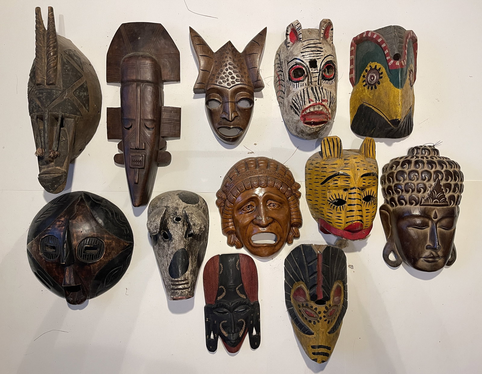 TWELVE MISC. CARVED, PAINTED MASKS: TWELVE MISC. CARVED, PAINTED MASKS