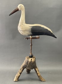LIFE SIZED POLYCHROME CARVED WOODEN STORK IN BRANCH LOG BASE