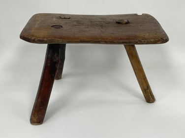 3 LEGGED MILKING STOOL IN REMNANTS OF OLD RED PAINT