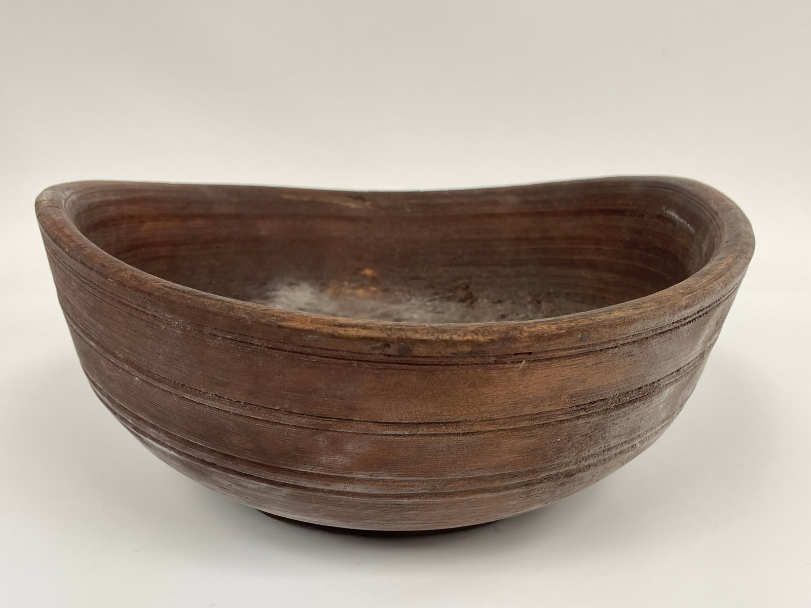 WELL WORN , AGE MISSHAPEN , WOODEN BOWL IN RED PAINT: WELL WORN , AGE MISSHAPEN , WOODEN BOWL IN RED PAINT 12" X 3"