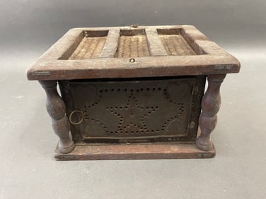 A 19th century foot stove with a star pattern