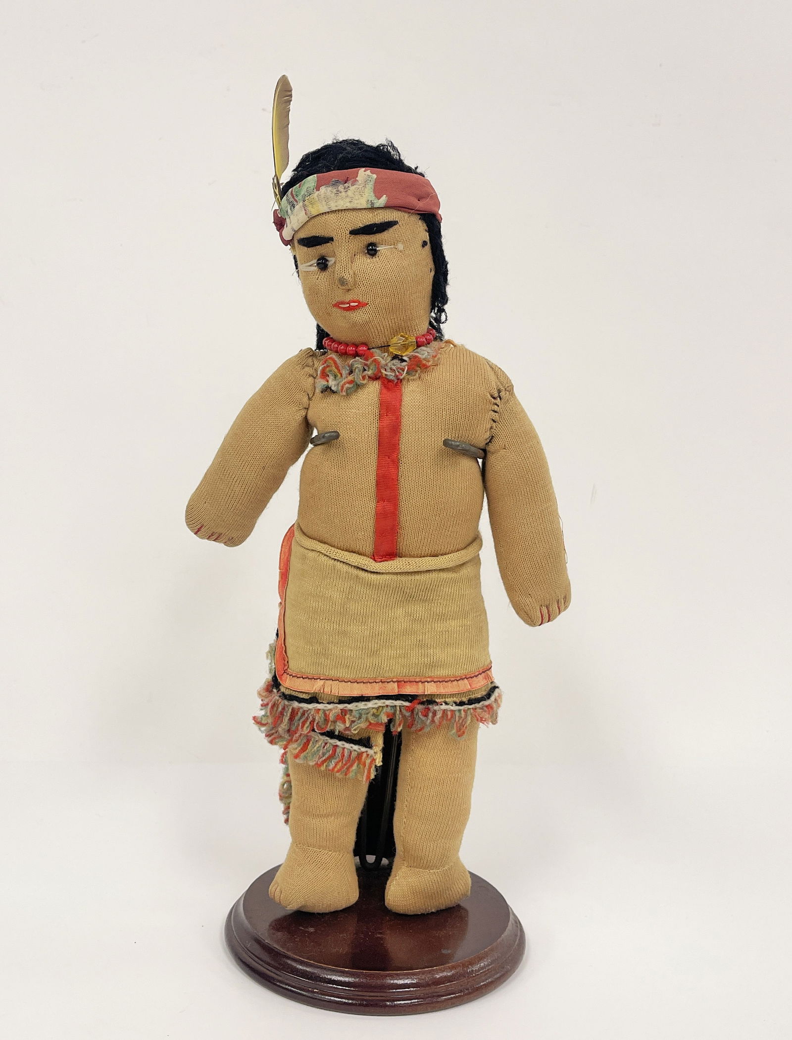 NATIVE AMERICAN DOLL: NATIVE AMERICAN DOLL Fabric stuffed, glass bead eyes, original clothing, early 20th C.