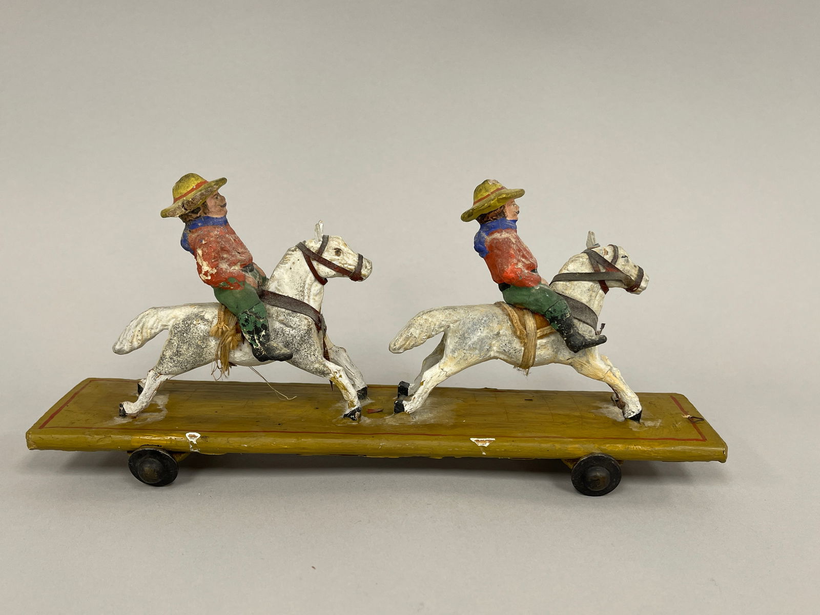 COWBOYS PULL TOY: COWBOYS PULL TOY Original paint, full bodied carved, early 20th C, excellent condition.