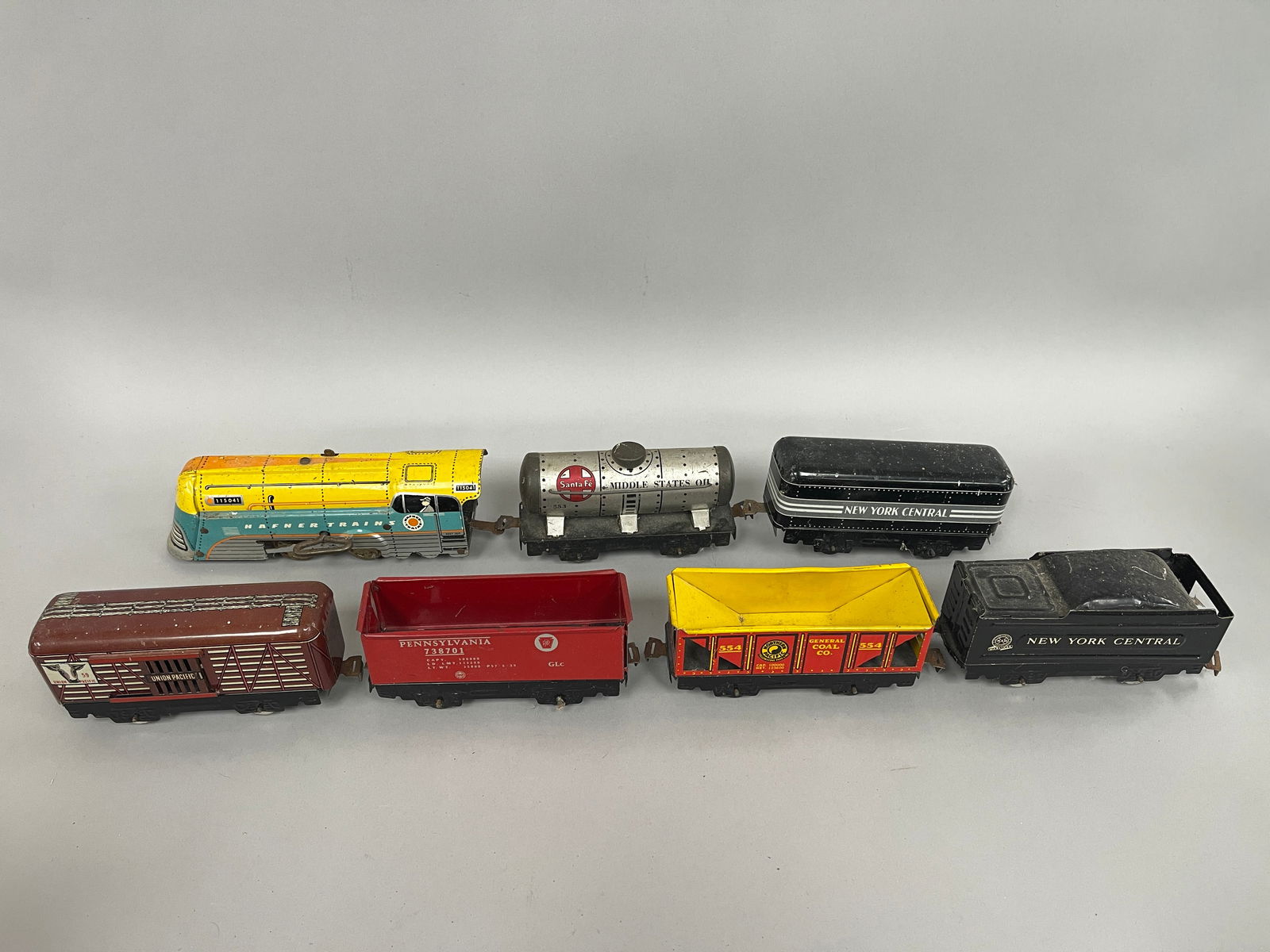 MINIATURE PRESSED STEEL TRAIN: MINIATURE PRESSED STEEL TRAIN Colorful set; locomotive & five cars, early 20th C, excellent condition.
