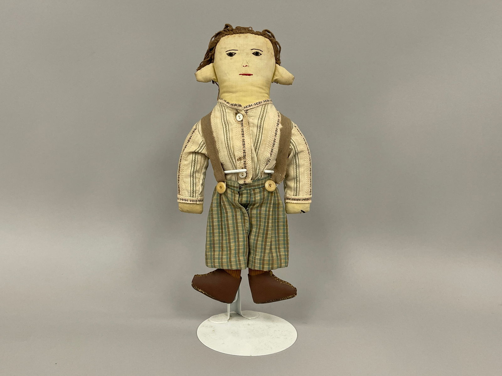 RARE BOY DOLL: RARE BOY DOLL Fabric stuffed, embroidered face, bead eyes, green checkered pants, early 20th C, excellent condition.