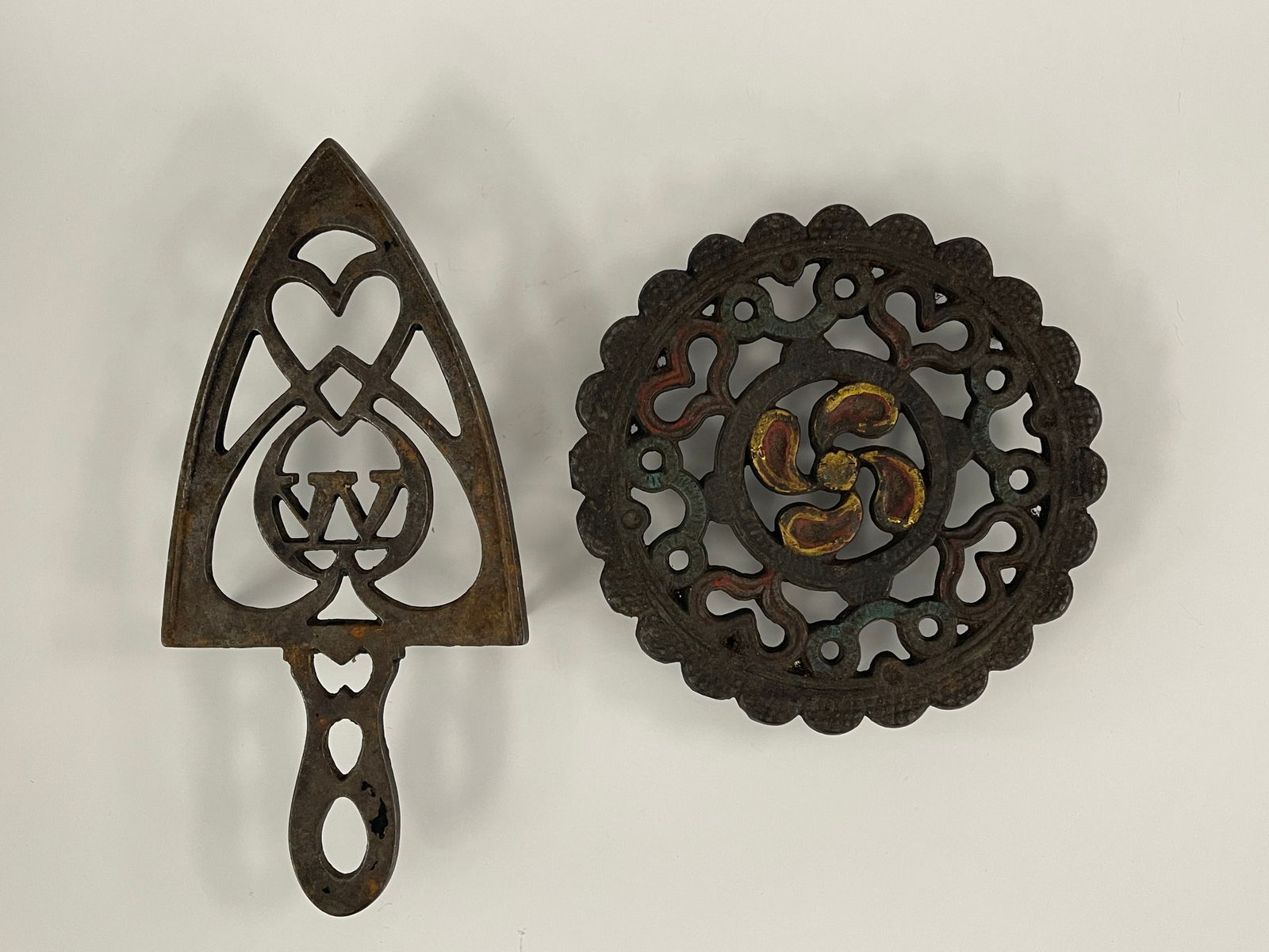 TWO EARLY IRON TRIVETS (1 of 3)