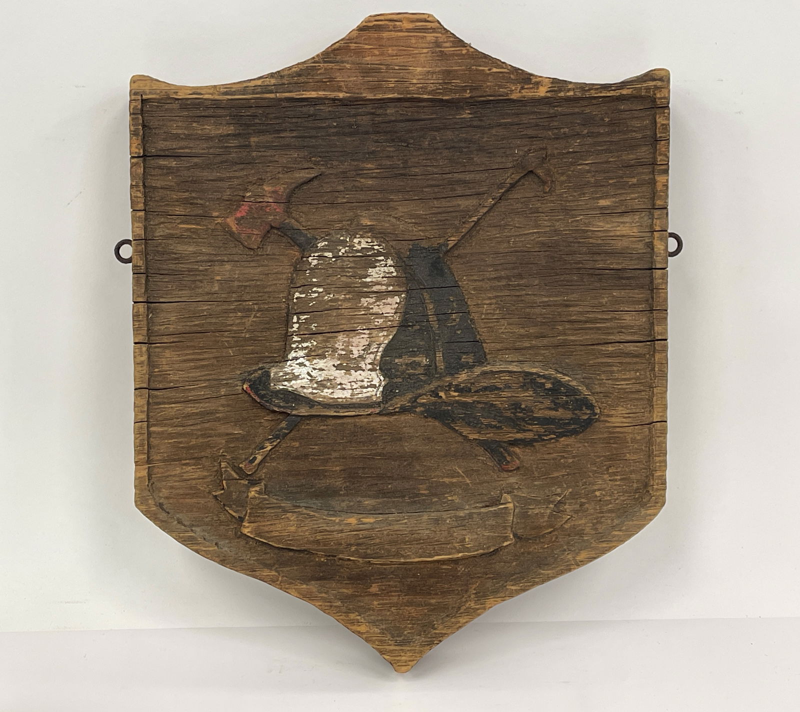 EARLY FIRE HOUSE PLAQUE: EARLY FIRE HOUSE PLAQUE WEATHERED OLD PAINT , DEPICTING " NEW YORK STYLE" FIRE HELMET WITH CROSSED AXES.