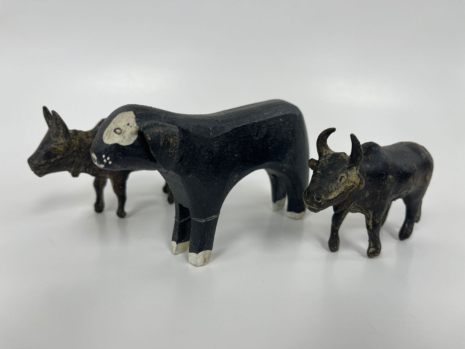 FOLK ART CARVED AND PAINTED DOG, TWO IRON STEER: FOLK ART CARVED AND PAINTED DOG, TWO IRON STEER