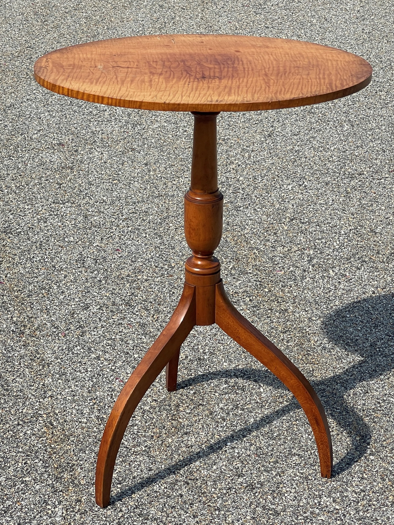 TIGER MAPLE SPIDER LEG CANDLE STAND: SPIDER LEG CANDLE STAND WITH OVAL FIGURED MAPLE TOP. NEW ENGLAND. C 1825. H 29-3/4"