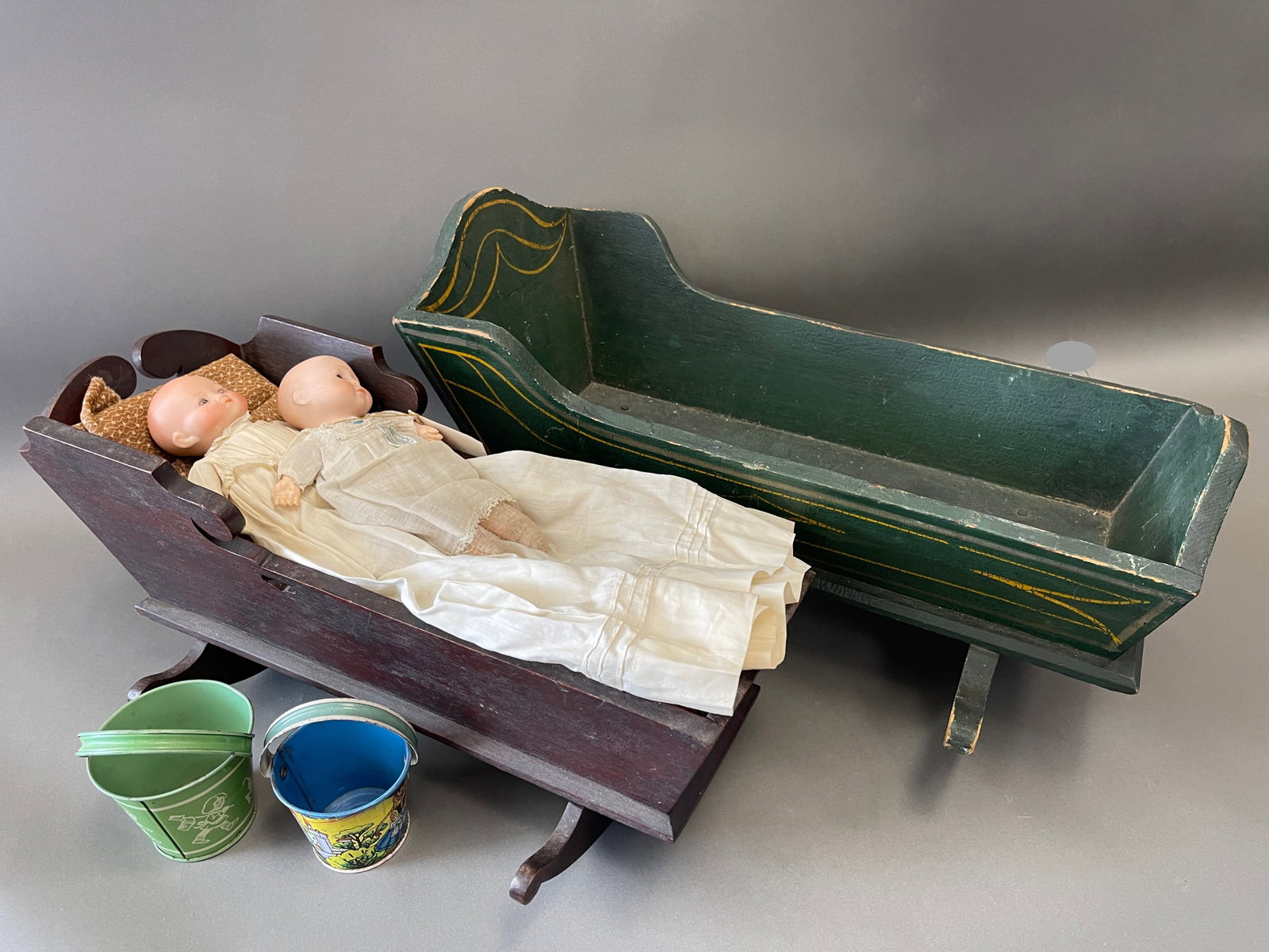 CHILD/DOLL GROUP: CHILD/DOLL GROUP: ANTIQUE DOLL CRADLE WITH BEDDING ADDED NEW:PAIR DOLLS: 8 ½” BISQUE MOTSCHMAN TYPE GERMAN POSSIBLE ARMOND MARCEILLE MARKED GERMANY ON THE BACK AND 8 ½”