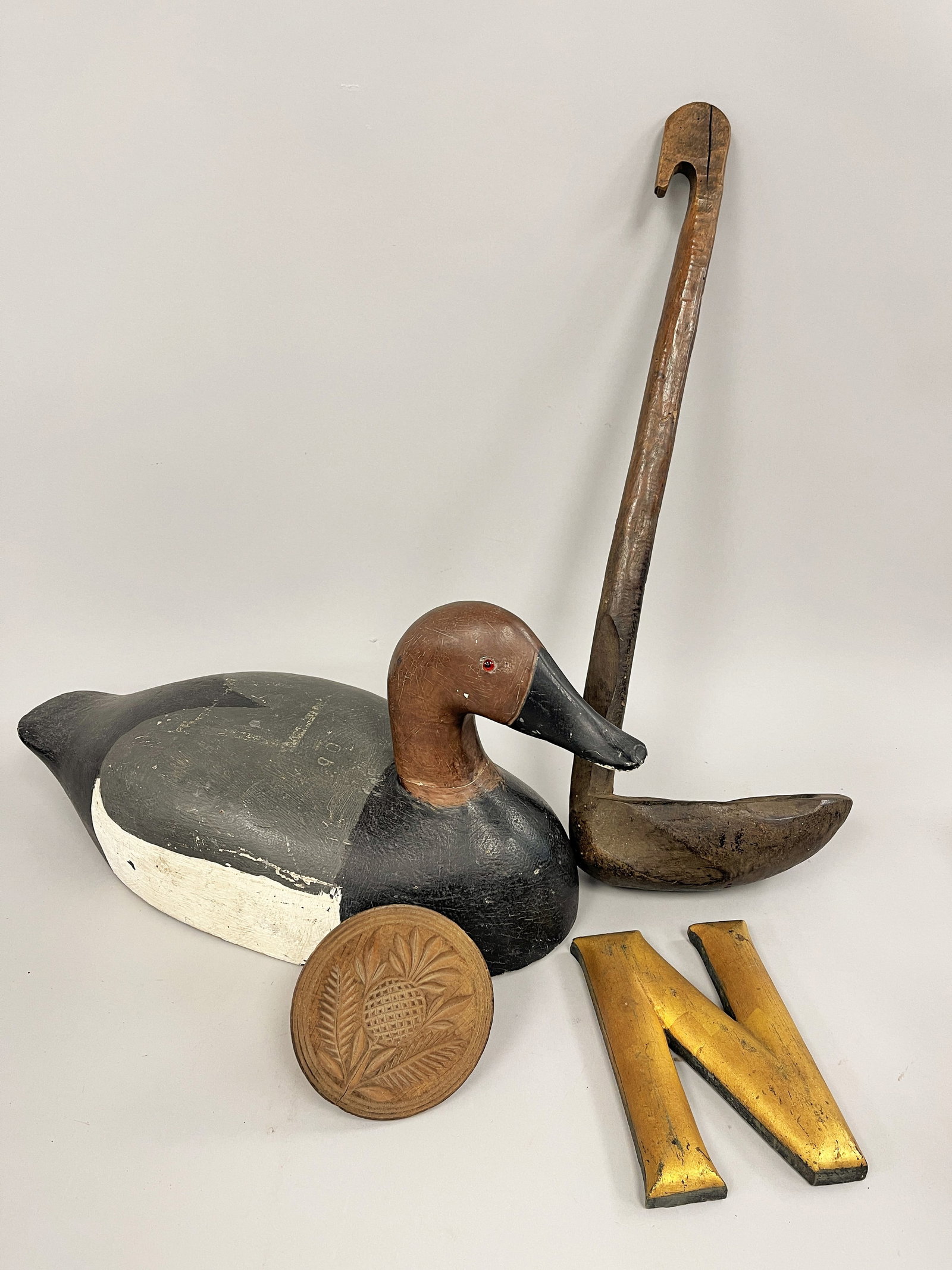 WOODEN LOT: WOOD LOT 18TH C UNUSUAL TURNED HANDLE 18THC WOODEN FAT SKIMMER 20 B. LETTER N GOLD PAINTED;C. 19TH C CARVED THISTLE BUTTER STAMP 4 3/8” X 3 ¼”D. 19 TH PAINTED DUCK DECOY