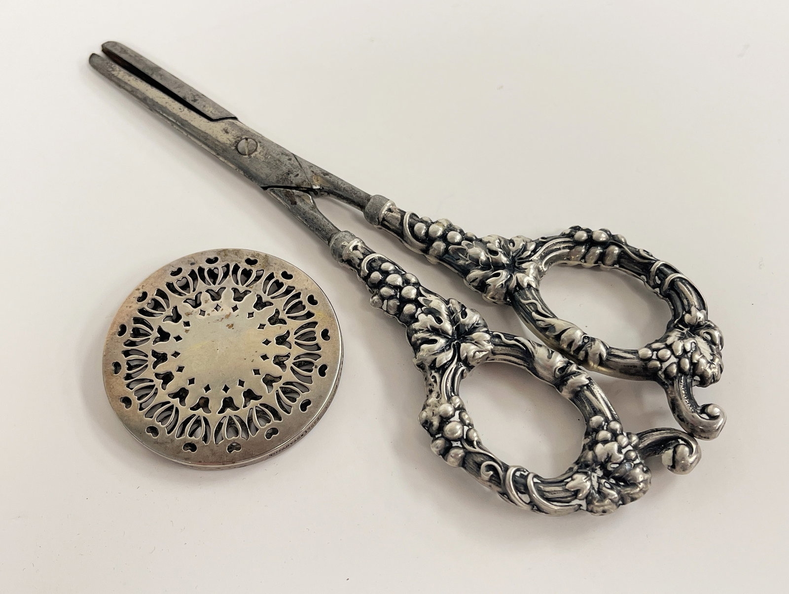 STERLING SILVER LOT, TIFFANY: SILVER LOT: A. C1920 TIFFANY & CO. STERLING PERFUME VINAIGRETTE. 17596 MAKERS 7249 MARKED STERLING 'M'" 1 7/8" DIAMETER X 1/8" B. MARKED STERLING SCISSORS CAN CLEEF CO. GERMANY 19THC 7"