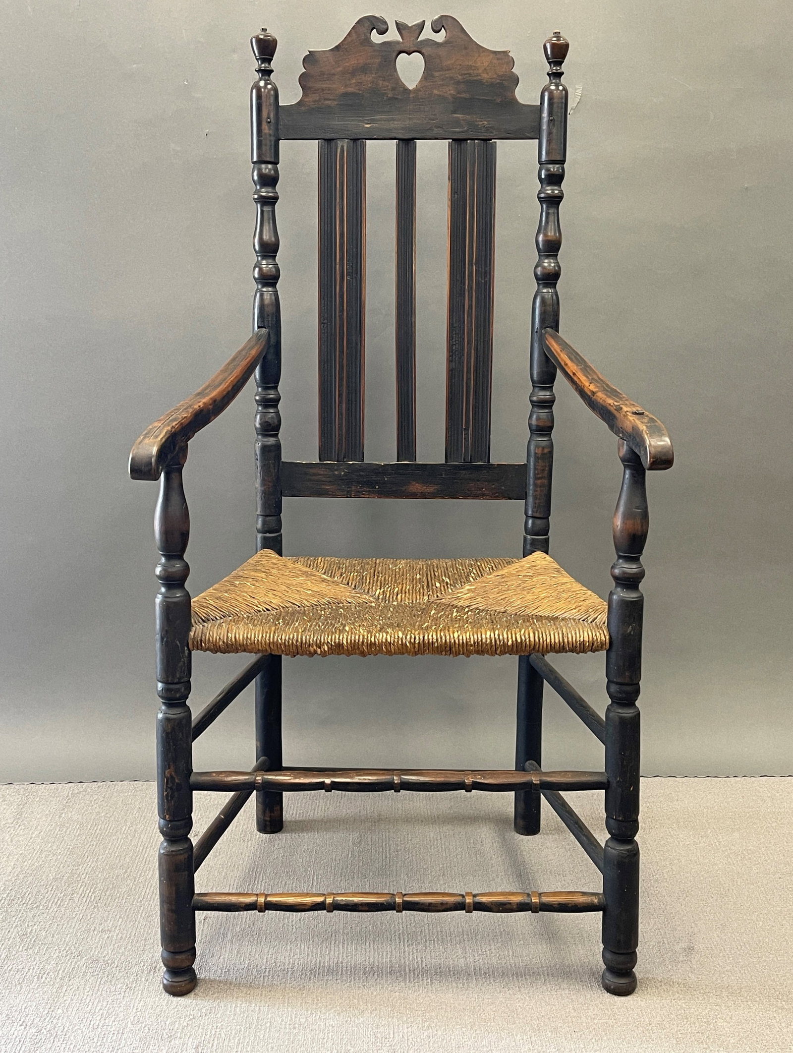RARE 18THC CT HEART AND CROWN BANNISTER BACK ARMCHAIR: RARE 18THC CT HEART AND CROWN BANNISTER BACK ARMCHAIR IN OLD BLACK PAINT 48" X 23" X 18"
