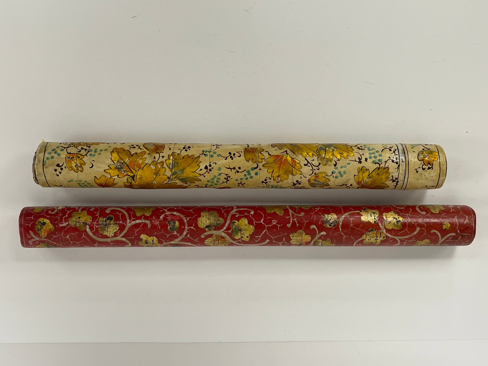 PAIR OF WALLPAPER COVERED TIN KNITTING NEEDLE TUBES: C 1830-1860 PAIR OF WALLPAPER COVERED TIN KNITTING NEEDLE TUBE. EACH TRADITIONAL TIN KNITTING NEEDLE LIDDED CASE WITH CARDSTOCK COVERING WITH ADDITIONAL APPLICATION OF HAND PAINTED FLORAL LEAF DESIGN