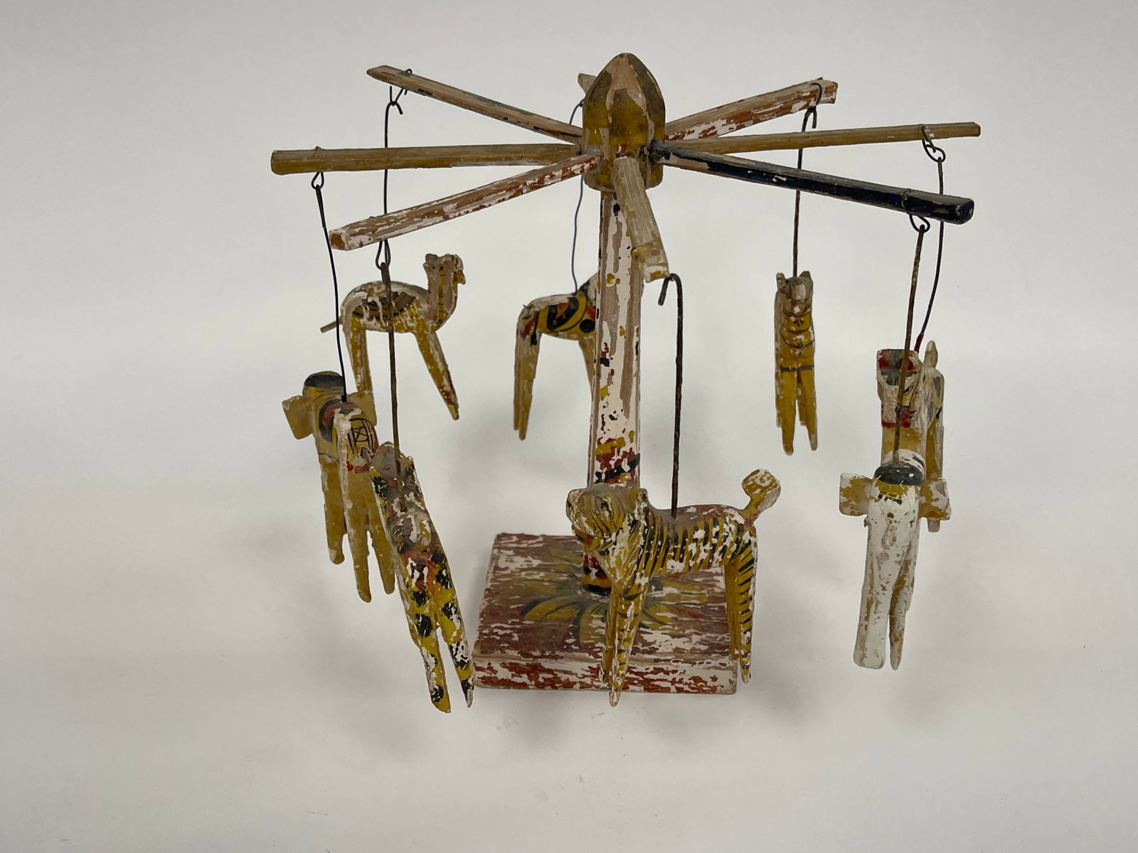 CARVED PAINTED CAROUSEL: CARVED PAINTED CAROUSEL , MOVING PARTS , HAND PAINTED PREVIOUSLY ON EXHIBIT AT THE HORNIMAN MUSEUM IN LONDON MADE IN AFRICA 9" TALL