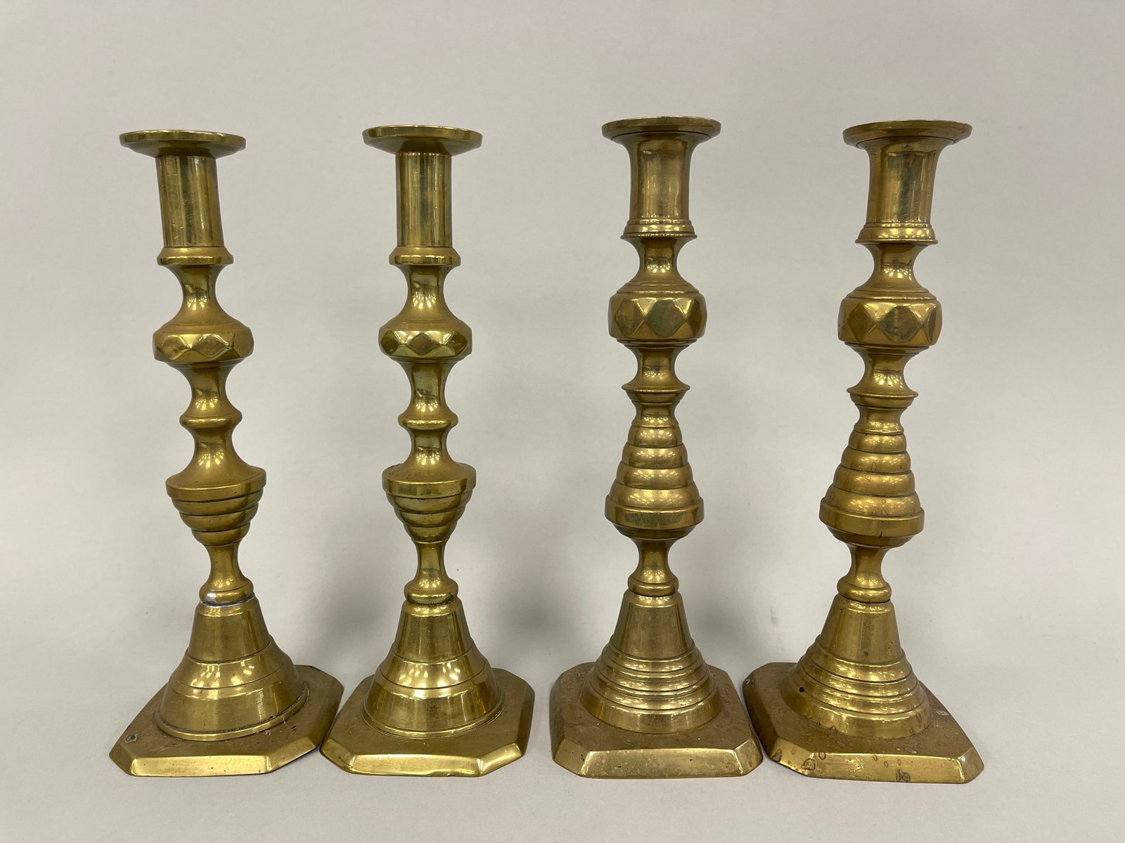 TWO PAIR OF BRASS PUSH UP CANDLESTICK: TWO PAIR OF BRASS PUSH UP CANDLESTICK 10"