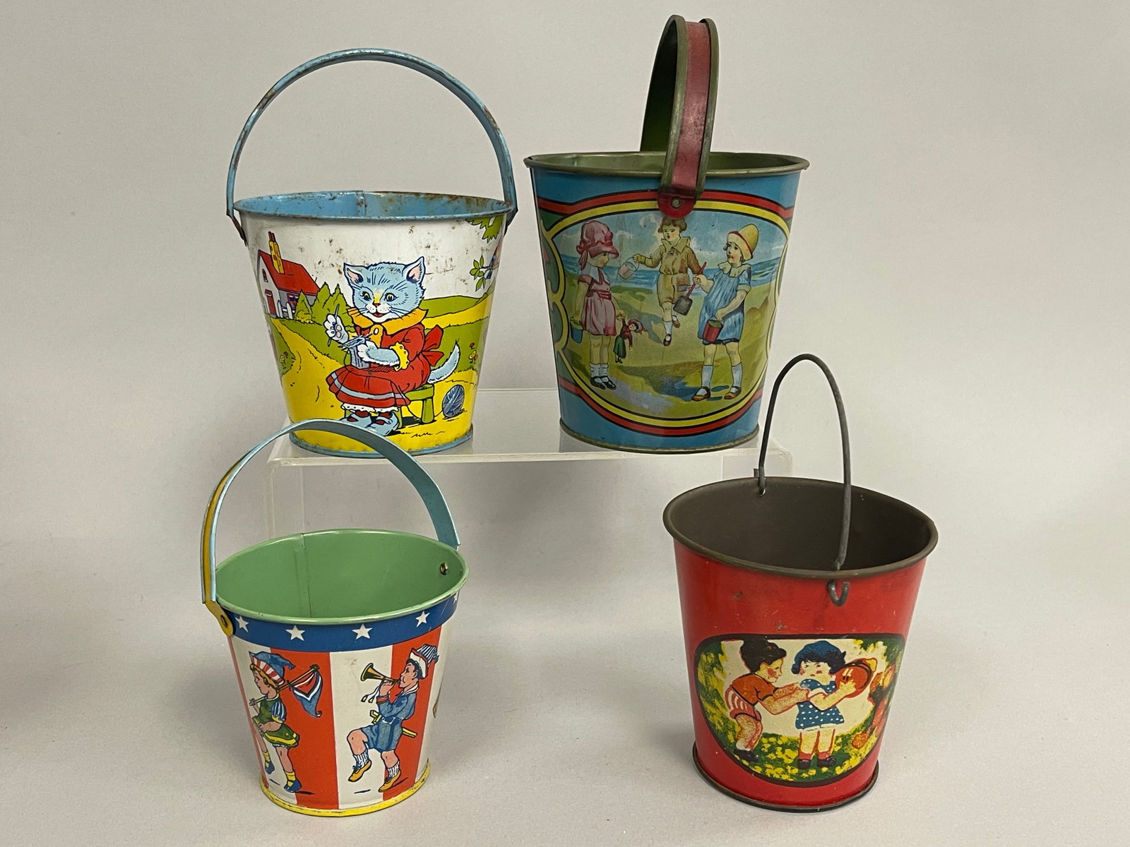 FOUR SMALL VINTAGE SAND PAILS: FOUR SMALL VINTAGE SAND PAILS