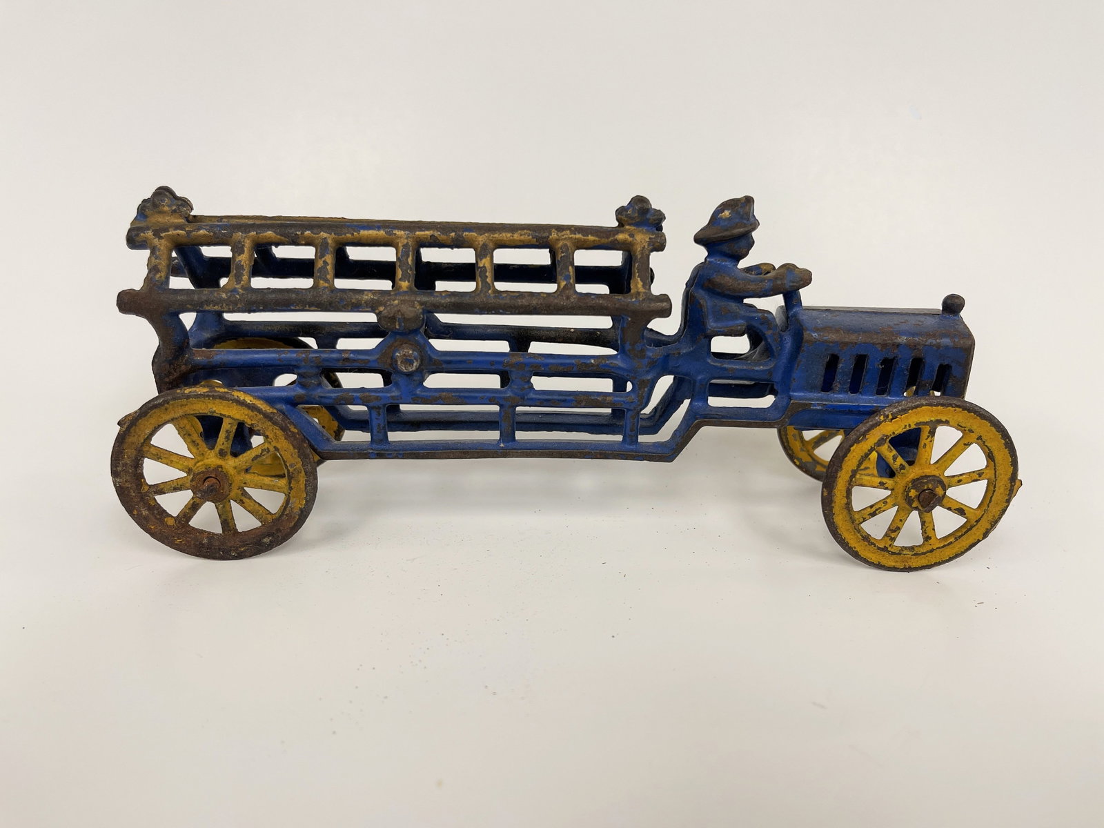 EARLY OPEN WORK FIRE LADDER TRUCK: EARLY OPEN WORK FIRE LADDER TRUCK LATE 19TH C, CAST IRON & PRESSED STEEL, RARE BLUE PAINTED EXAMPLE, EXCELLENT CONDITION