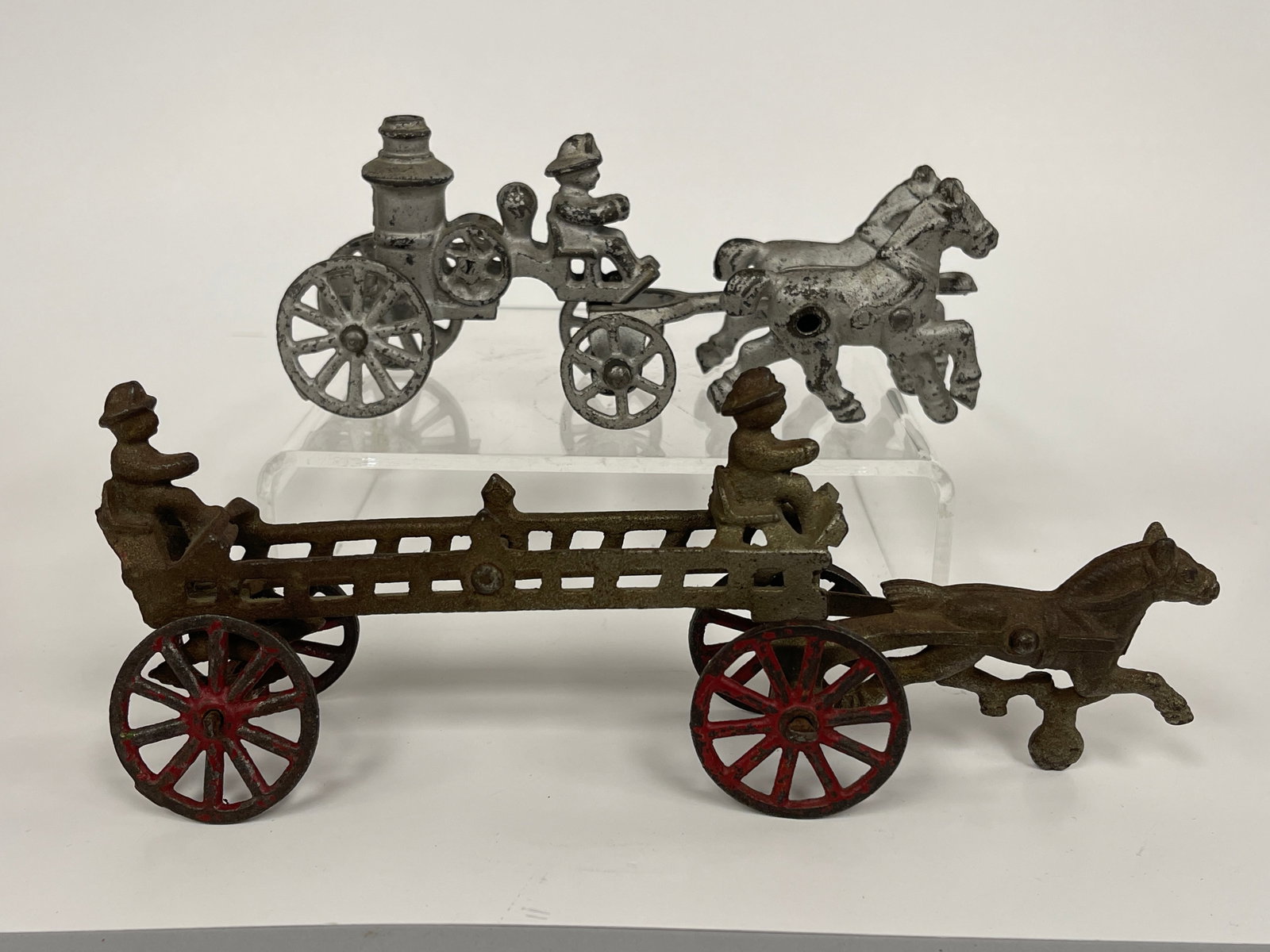 2 IRON FIRE WAGON TOYS: 2 IRON FIRE WAGON TOYS 19TH C, CAST IRON, ONE A LADDER TRUCK, THE OTHER A PUMPER, EXCELLENT CONDITION.