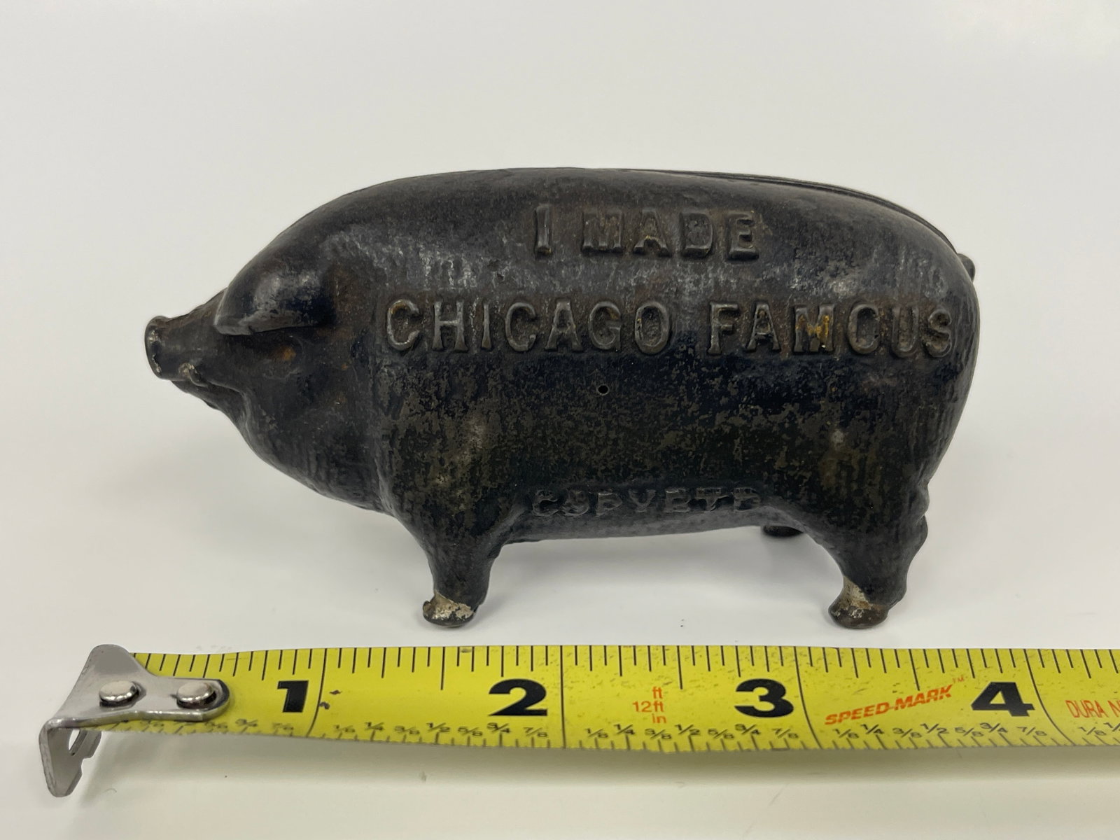 “I MADE CHICAGO FAMOUS?? EMBOSSED PIG BANK: “I MADE CHICAGO FAMOUS” EMBOSSED PIG BANK DATED 1902, CAST IRON, ORIGINAL PAINT, EXCELLENT CONDITION.