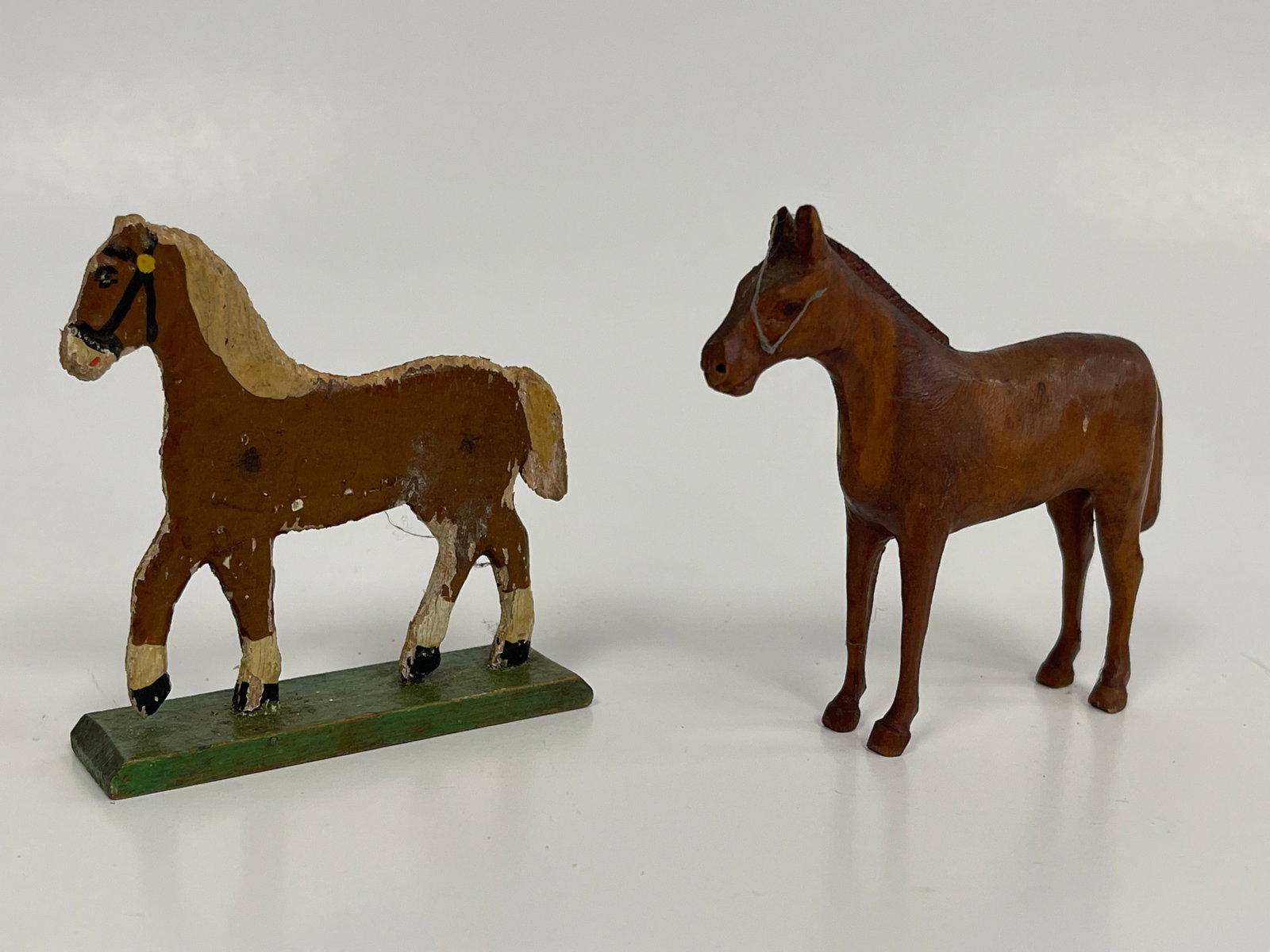 2 SMALL CARVED HORSES: 2 SMALL CARVED HORSES C 1900. ONE FINELY FULL BODY CARVED, OTHER FLAT CARVED ON BASE, ORIGINAL SURFACES, EXCELLENT CONDITION.