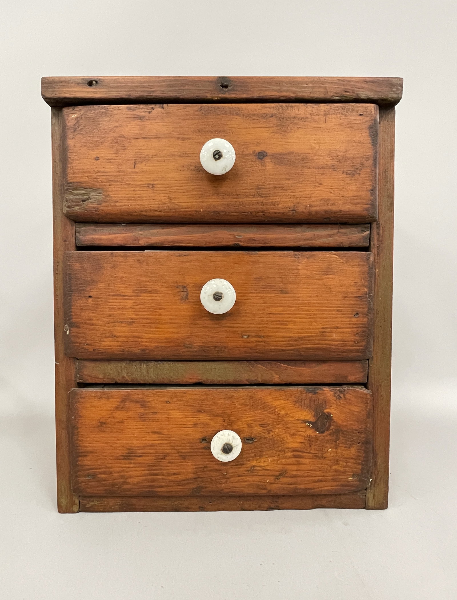MINIATURE CHEST OF DRAWERS: MINIATURE CHEST OF DRAWERS C 1840, PINE, OLD SURFACES, ORIGINAL PORCELAIN KNOBS, EXCELLENT OVERALL CONDITION.