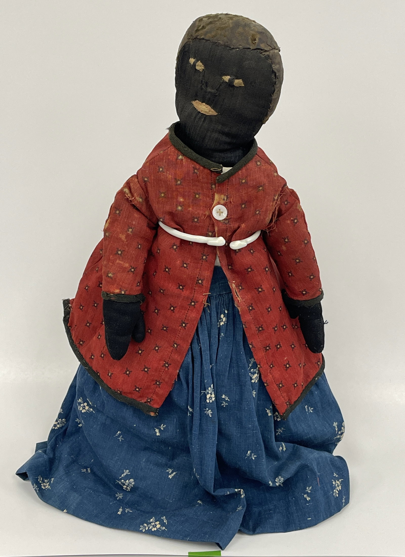 EARLY BLACK RAG DOLL: EARLY BLACK RAG DOLL 19TH C, EMBROIDERED FACE, BLUE DRESS, RED COAT