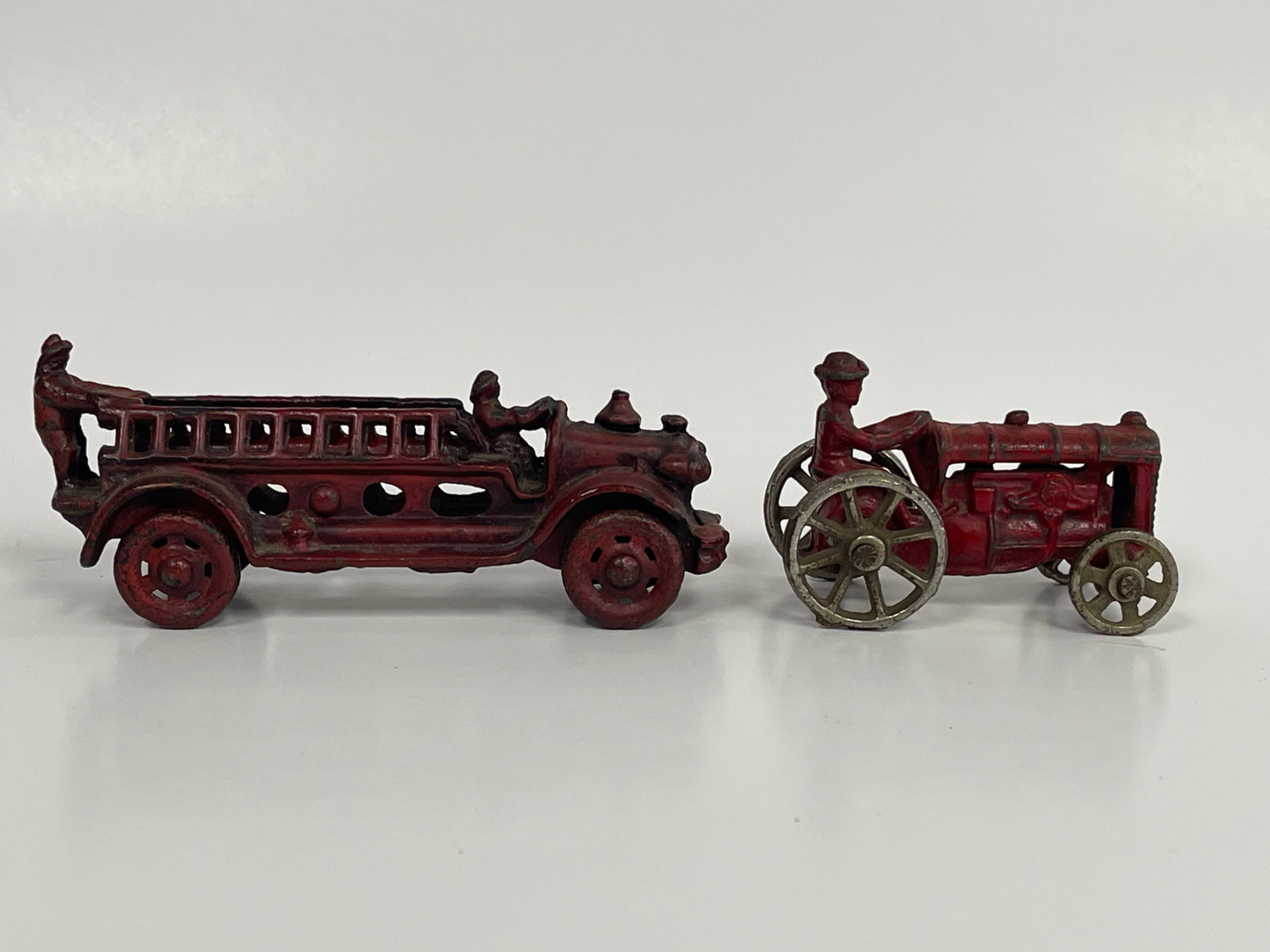 LADDER FIRE TRUCK & FARM TRACTOR TOYS: LADDER FIRE TRUCK & FARM TRACTOR TOYS EARLY 20TH C, CAST IRON, EXCELLENT CONDITION.